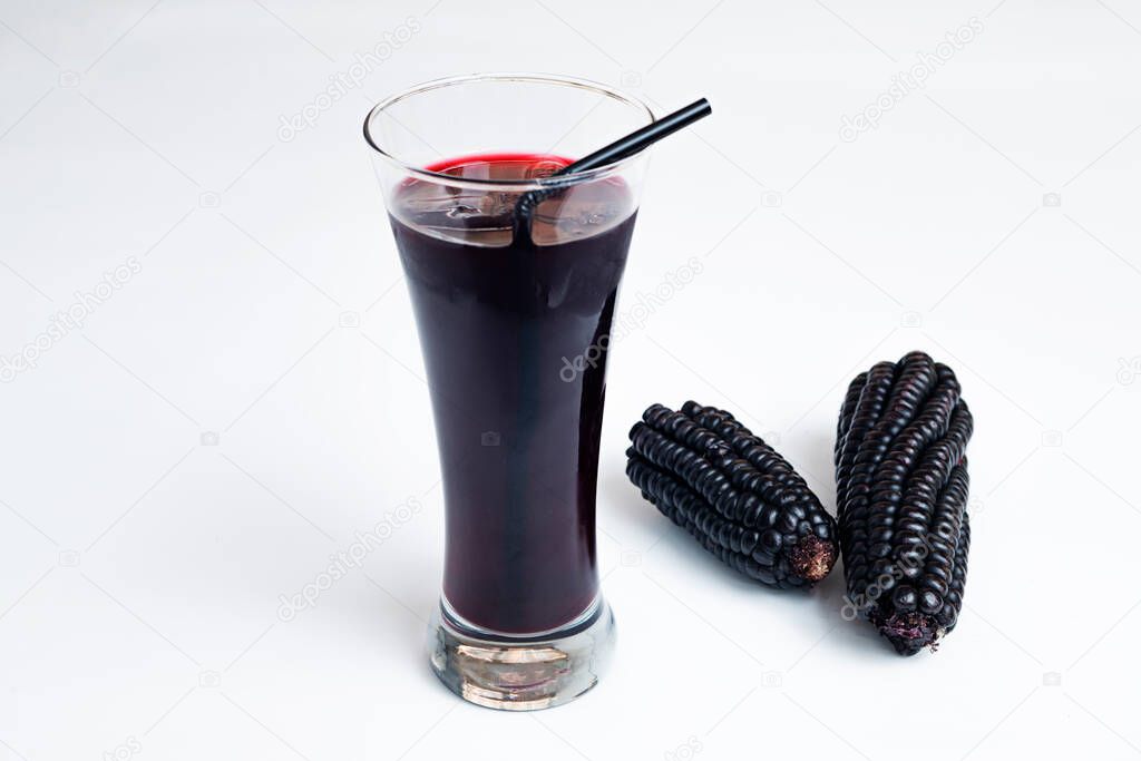 Image of superfood with juice from it. Peruvian chicha morada with purple corn juice, pineapple, apples and lemons