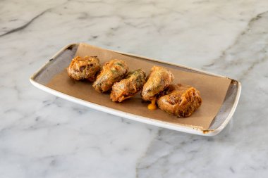 Gri tepside sebze ve erimiş çedar peyniri dolu börekler için nefis bir tarif.