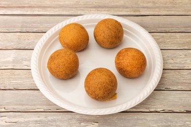 Beyaz plastik tabakta Kolombiya mısır unu böreği.