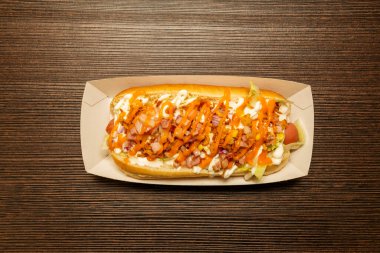 Top view image of hot dog with crispy onion, salad and ham tacos with cheddar cheese and mayonnaise sauces
