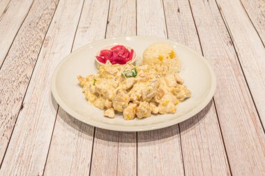 Mexican chicken stew with pumpkin flower, purple onion and white rice