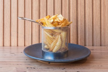 Gourmet fries, triple-cooked for maximum crispiness, presented on a board with BBQ sauce