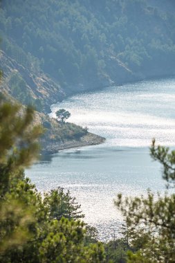 Summer sunrise captured with long exposure where the reservoir water appears as a sedated surface