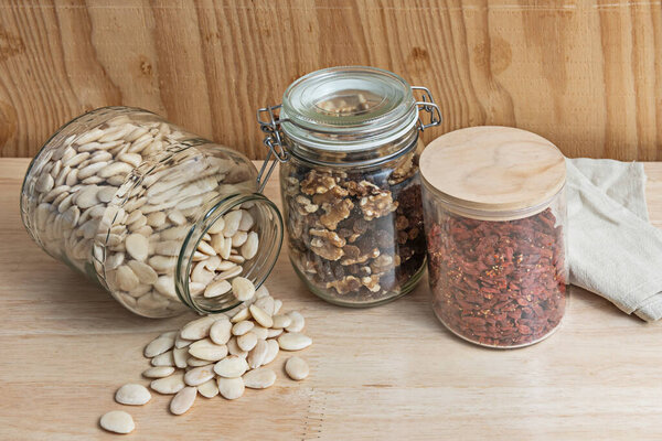 Gourmet selection of fried almonds, currants, toasted macadamia nuts, and goji berries on porcelain