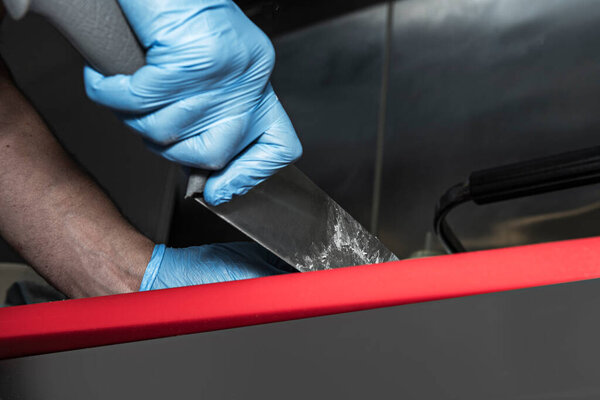 The over-fermented focaccia dough bubbles between the baker's fingers as he performs the final degassing on the veined granite countertop.