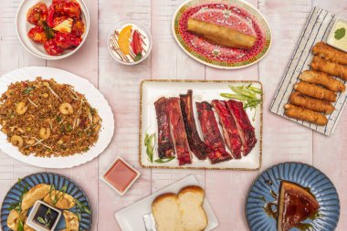 Baharatlı doubanjiang soslu çift kızartılmış domuz parçaları, yanında sarımsaklı lahanalar ve istiridye mantarları, aile tabağında sunuluyor.