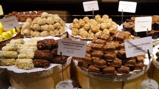 Figuras de chocolate em uma variedade de formas exibidas em confeiteiro de prestígio — Vídeo de Stock