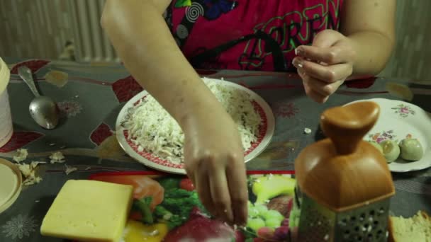 Primer plano de las manos de la mujer preparándose, y decorado con ensalada de verduras en la cocina — Vídeos de Stock