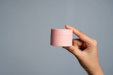 Gri Arka plan Stüdyo Çekimine Karşı Lid ile Küçük Pembe Silindirik Konteynır