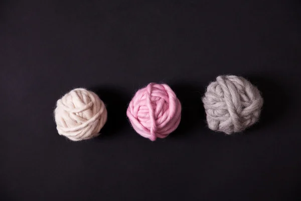 Colorful yarn clews on black background — Stock Photo, Image