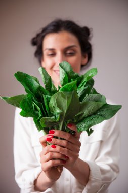 Young woman hands with spinach