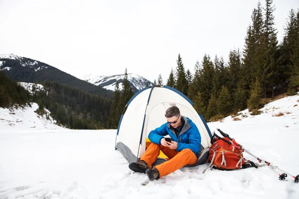Randonneur en montagne hivernale avec smartphone — Photo