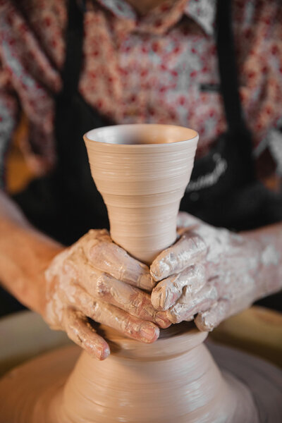 Unrecognizable potter master creating new ceramic pot