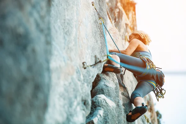 Rock climbing on vertical flat wall - Stock image Stock Image
