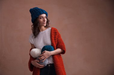 Kadın örgü kazak ve iplik clews holding şapkası