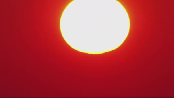 Timelapse, un grand soleil se couche dans des nuages orange qui deviennent bleus. — Video