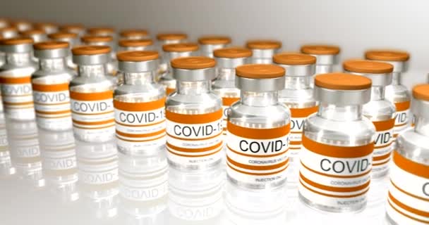 Žluté láhve koronavirová vakcína COVID-19. Skleněné injekční lahvičky s vakcínou Sars-cov-2. hladká smyčka 3d vykreslování pro editaci videa, smyčka pro editaci videa, smyčka — Stock video