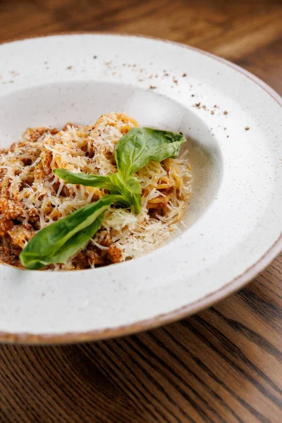 İçinde peynir ve taze bitkiler bulunan çeşitli makarna tabakları sunuluyor. Her yemek eşsiz tatlar ve yemek teknikleri sergiliyor, lezzet keşiflerini teşvik ediyor..