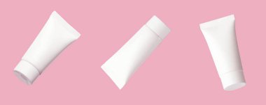 Pembe arka planda kozmetik ürünleri için boş plastik tüp. Asgari konsept.