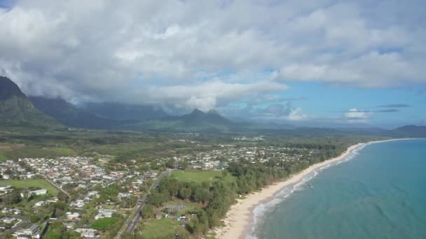 Colorata vista aerea delle montagne rocciose. Una spiaggia tropicale con acque turchesi blu oceano e onde che lambiscono su una spiaggia di sabbia bianca nascosta. Waimanalo Beach, Isola di Oahu, Hawaii. — Video Stock