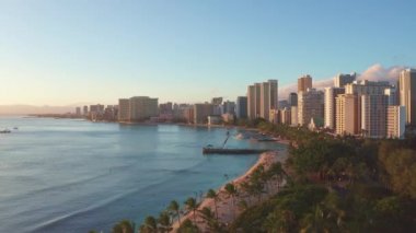 Hawaii, Oahu 'da gün batımında Waikiki Sahili kuşbakışı çekim yaparken hava aracı yavaşça Honolulu siluetinin üzerinden uçuyor. Hawaii adası Oahu 'nun muhteşem dağları.