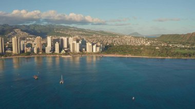 Waikiki Sahili ve Diamond Head Krateri 'nin gün batımında insansız hava aracı görüntüsü. Honolulu, Oahu, Hawaii, ABD' de ünlü bir turizm merkezi. Waikiki Sahili, arka planda Honolulu silueti.