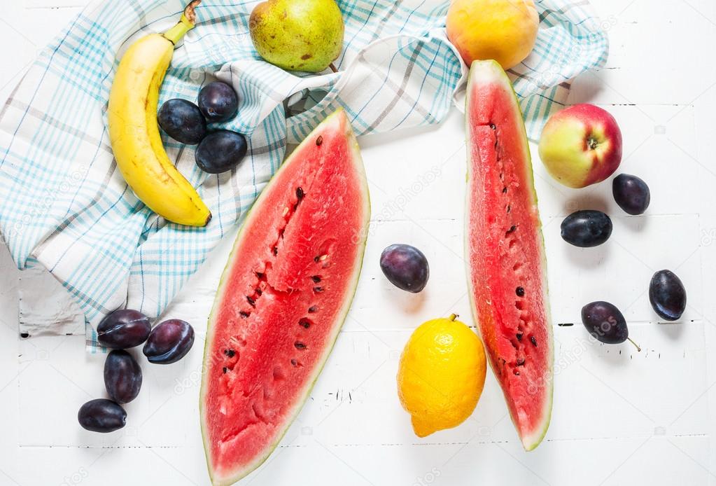 Colorful various of organic farm fruits on wooden rustic background top view