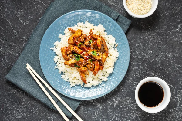 Homemade sesame Chicken served with Jasmine white rice. Top view