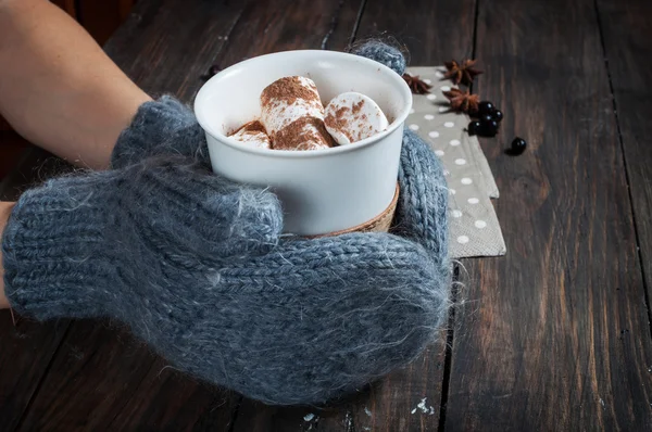 Manos en manoplas de punto con chocolate caliente y malvavisco — Foto de Stock