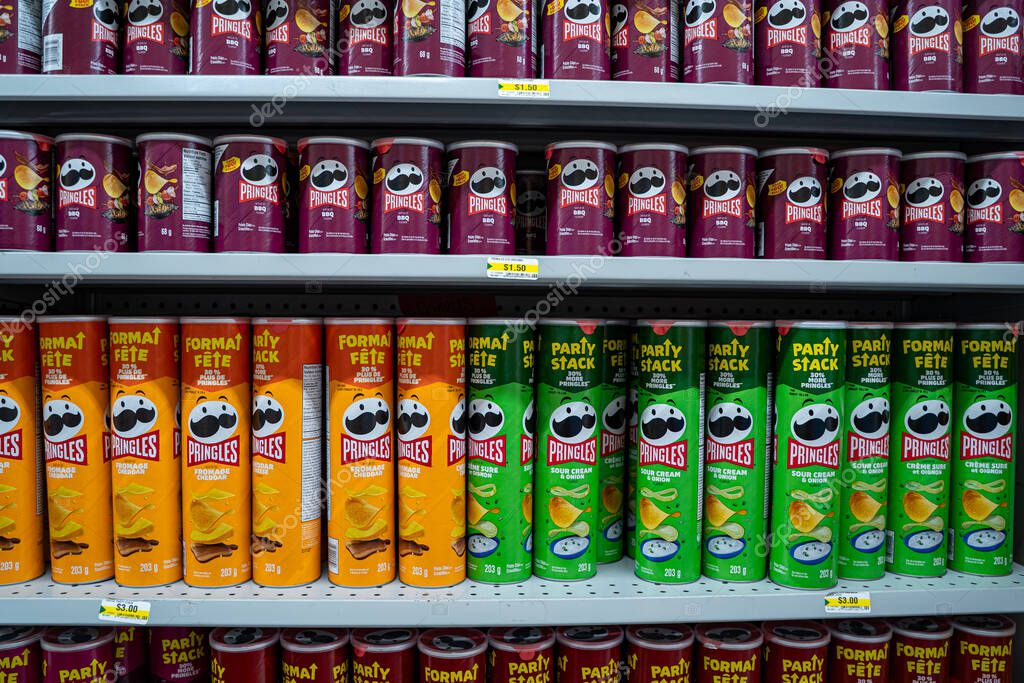 Pringles chips cans displayed on grocery store shelf. Toronto, Canada - September 18, 2025.
