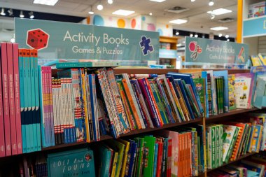 Bir oyun ve bulmaca rafında düzenlenmiş çocuk aktivite kitaplarının görüntüsü. Toronto, Kanada - 3 Aralık 2025.