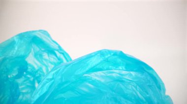 Beyaz arkaplandaki mavi plastik torbaların makrosu izole edildi