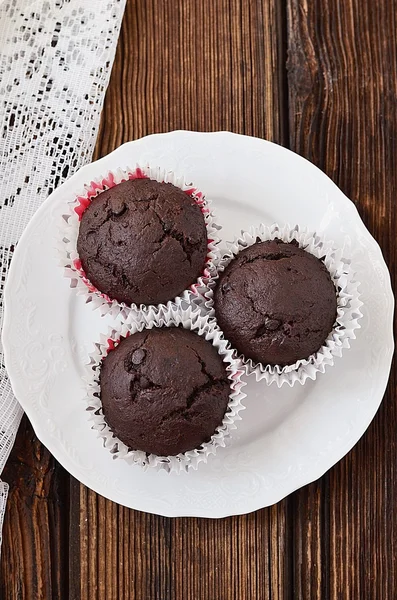 Chocolate muffins on a wooden table — Stock Photo, Image