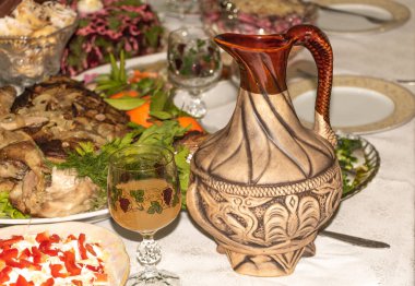 Bir bardak beyaz şarap ve yemek dolu masanın üzerindeki sürahi. Tatil Konsepti