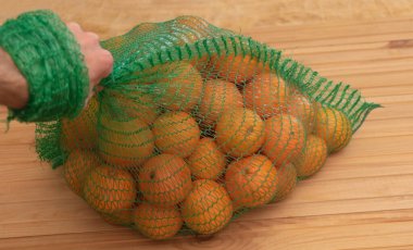 A lot of oranges in a bag - benefits of oranges concept. Selective focus.