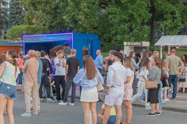 People gathering at outdoor street event with food and drink stands - Chisinau, Moldova - August 27 2025.