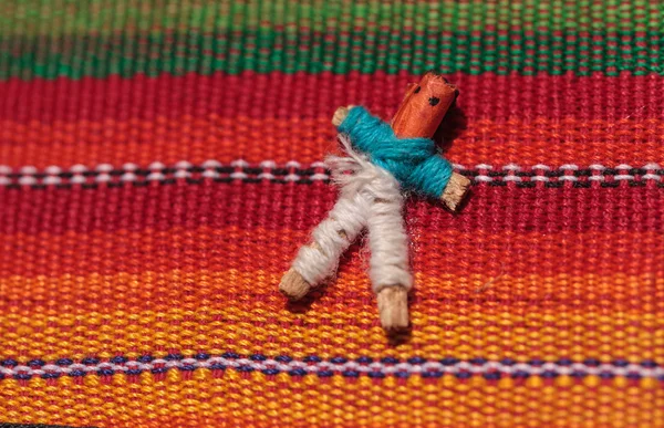Macro of a handmade little textured Mexican cloth doll