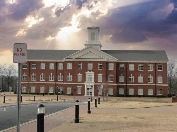 Wake Forest, North Carolina, USA - December 5, 2015: Sun shines through clouds over the Southeastern Baptist Theological Seminary in Wake Forest, North Carolina.