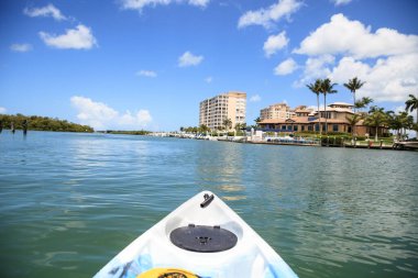 Cocohatchee River leads out to the ocean in Naples, Florida from a kayak. clipart