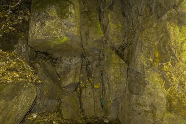 Wall cave with large stone brass color — Stock Photo, Image