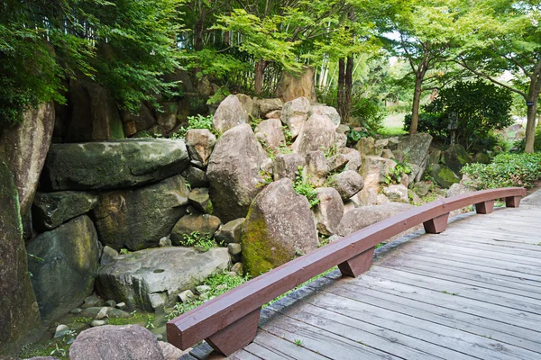 Big rocks under trees with woodbridge — Stock Photo, Image