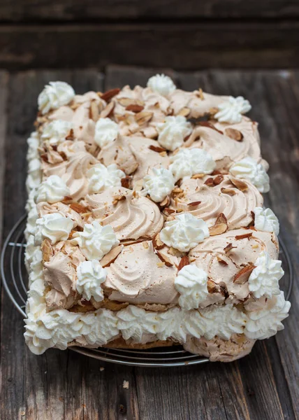 Meringue cake, whipped cream and almonds — Stock Photo, Image