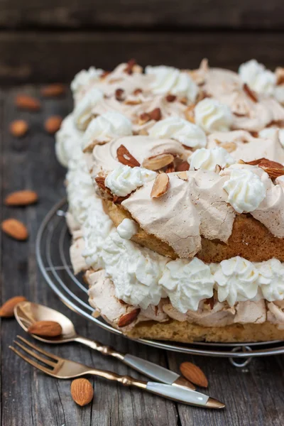 Meringue cake, whipped cream and almonds — Stock Photo, Image