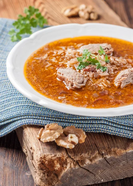 Kharcho soup with lamb, tkemali, rice and walnuts. — Stock Image Kharcho soup with lamb, tkemali, rice and walnuts. Stock Picture