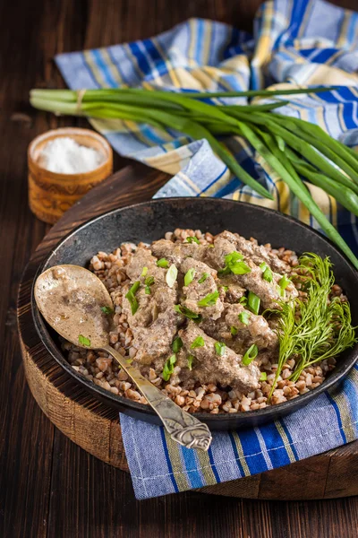 Beef Stroganoff with sour cream and garnish of buckwheat