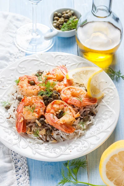 Shrimp with capers, lemon and wild rice — Stock Photo, Image