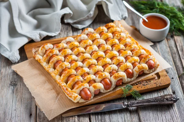 Sausages in the dough with ketchup — Stock Photo, Image