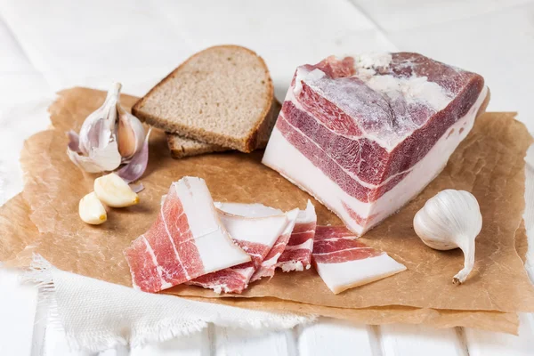 Salty bacon with garlic and black pepper. — Stock Image Salty bacon with garlic and black pepper. Stock Picture
