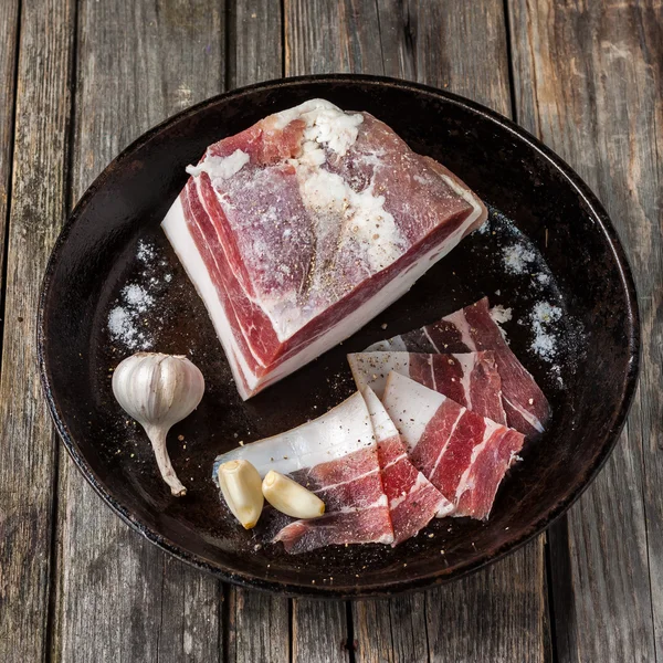Salty bacon with garlic and black pepper. — Stock Image Salty bacon with garlic and black pepper. Stock Picture