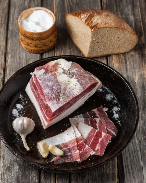 Salty bacon with garlic and black pepper. — Stock Image Salty bacon with garlic and black pepper. Stock Image